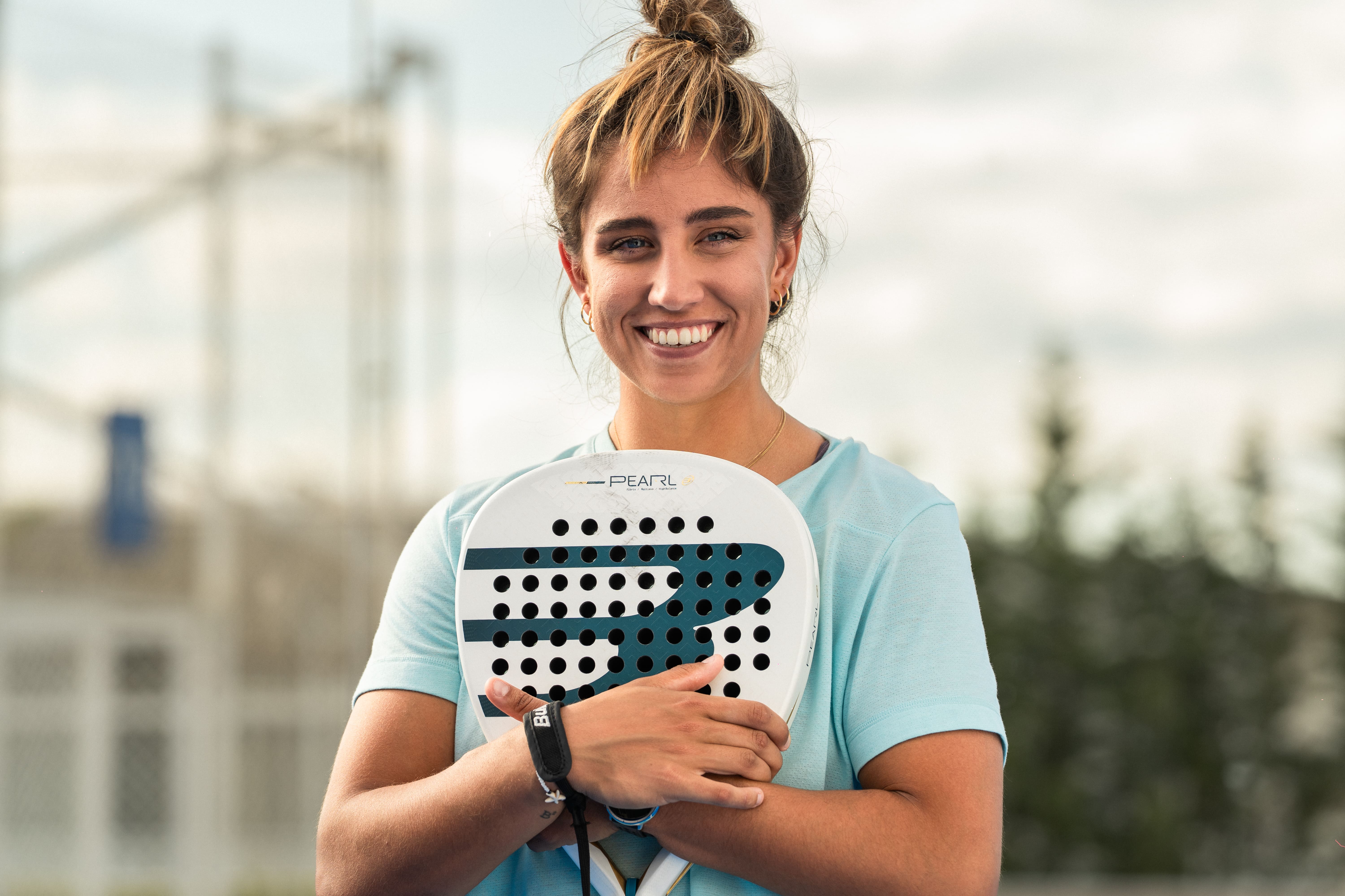 Bea González hugging her Bullpadel Pearl 2027 racket on court